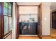 Modern laundry room featuring front-loading washer and dryer behind wood doors at 929 Hampton Nw Trl, Lilburn, GA 30047