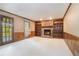 Cozy living room with brick fireplace, built-in bookshelves, and a door leading to the outdoors at 929 Hampton Nw Trl, Lilburn, GA 30047