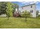 Well-maintained backyard featuring a sprawling lawn, a wooden deck, and mature trees at 1188 To Lani Farm Rd, Stone Mountain, GA 30083
