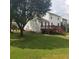Expansive backyard featuring lush green grass and a wooden deck, great for entertaining at 1188 To Lani Farm Rd, Stone Mountain, GA 30083