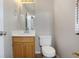 This bathroom features a toilet, a light wood vanity, and a wall mirror at 1188 To Lani Farm Rd, Stone Mountain, GA 30083