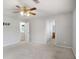 This bedroom offers neutral carpeting, a ceiling fan, and access to an ensuite bathroom at 1188 To Lani Farm Rd, Stone Mountain, GA 30083