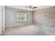 This bedroom boasts a decorative wall, large window, and neutral carpeting at 1188 To Lani Farm Rd, Stone Mountain, GA 30083