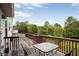 A spacious wooden deck with ample seating provides a tranquil outdoor space with a green view at 1188 To Lani Farm Rd, Stone Mountain, GA 30083