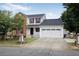 Charming two-story home with a brick facade and a spacious two-car garage, set against a backdrop of mature trees at 1188 To Lani Farm Rd, Stone Mountain, GA 30083