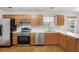 Modern kitchen with stainless steel appliances, hardwood floors, light colored cabinets, and ample counter space at 1188 To Lani Farm Rd, Stone Mountain, GA 30083