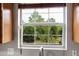 Kitchen window with wood trim and a scenic view at 1188 To Lani Farm Rd, Stone Mountain, GA 30083