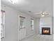 Inviting living room featuring a cozy fireplace, ample windows, and neutral decor at 1188 To Lani Farm Rd, Stone Mountain, GA 30083