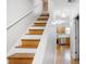 A staircase leads to a bright kitchen with stainless steel appliances at 1188 To Lani Farm Rd, Stone Mountain, GA 30083