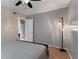 A serene bedroom with neutral walls, warm carpet flooring, and stylish floor lamp, inviting relaxation at 148 Waverly Way # 10, Atlanta, GA 30307