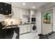 Efficient kitchen featuring white cabinetry, and space-saving appliances for a modern look at 148 Waverly Way # 10, Atlanta, GA 30307