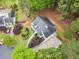 Aerial view of the home with a large driveway and beautiful landscaping in a wooded setting at 1633 Clifton Downs Ct, Kennesaw, GA 30144