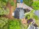 Overhead aerial view of the roof and backyard of the home, set among tall, mature trees at 1633 Clifton Downs Ct, Kennesaw, GA 30144