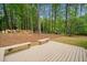 Scenic backyard deck with wood benches, surrounded by a peaceful wooded environment at 1633 Clifton Downs Ct, Kennesaw, GA 30144