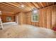 Unfinished basement space with wood framing, windows, and potential for customization at 1633 Clifton Downs Ct, Kennesaw, GA 30144