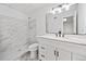 Modern bathroom featuring marble-look tile, a stylish vanity, and sleek fixtures at 1633 Clifton Downs Ct, Kennesaw, GA 30144