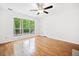 Bedroom with hardwood floors, ceiling fan, and large window at 1633 Clifton Downs Ct, Kennesaw, GA 30144