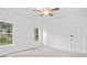 Bright bedroom with neutral carpet, white walls, a ceiling fan, and two windows overlooking the outdoors at 1633 Clifton Downs Ct, Kennesaw, GA 30144