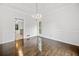 Dining room with hardwood floors, chandelier, and view into the kitchen at 1633 Clifton Downs Ct, Kennesaw, GA 30144