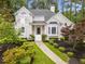 Charming home with a landscaped front yard featuring mature trees and manicured bushes at 1633 Clifton Downs Ct, Kennesaw, GA 30144