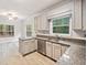 Kitchen with granite counters, stainless appliances, and a view to the large front windows at 1633 Clifton Downs Ct, Kennesaw, GA 30144