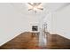Living room with dark hardwood floors, fireplace, and ceiling fan at 1633 Clifton Downs Ct, Kennesaw, GA 30144