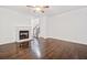 Living room featuring dark hardwood floors, fireplace, and a ceiling fan at 1633 Clifton Downs Ct, Kennesaw, GA 30144