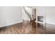 Open-concept living room with hardwood floors, fireplace, and staircase to the second floor at 1633 Clifton Downs Ct, Kennesaw, GA 30144