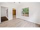 Light-filled living room with hardwood-style floors and a large window overlooking the yard at 1633 Clifton Downs Ct, Kennesaw, GA 30144