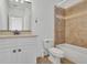 Bathroom with single vanity, decorative mirror and tub/shower combo at 2932 Springbluff Ln, Buford, GA 30519