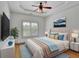 Comfortable bedroom with tray ceilings, ceiling fan and bright natural light at 2932 Springbluff Ln, Buford, GA 30519