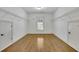 Walk-in closet featuring white shelving, neutral paint and hardwood flooring at 2932 Springbluff Ln, Buford, GA 30519