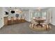Open dining area with a modern chandelier, bar, and table with seating at 2932 Springbluff Ln, Buford, GA 30519