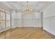 Formal dining room with decorative chandelier, tray ceiling, and wainscoting at 2932 Springbluff Ln, Buford, GA 30519