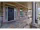 Welcoming front porch with stone flooring, brick walls and stately white columns at 2932 Springbluff Ln, Buford, GA 30519