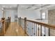 Upstairs hallway featuring wood floors, iron railing and coffered ceilings at 2932 Springbluff Ln, Buford, GA 30519
