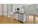 Kitchen island featuring granite countertops, stainless steel dishwasher, and white wood facade at 2932 Springbluff Ln, Buford, GA 30519