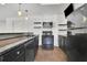 Modern kitchen with black appliances, granite counters, and ample storage space at 2932 Springbluff Ln, Buford, GA 30519