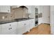 Modern kitchen featuring white cabinets, granite countertops, and stainless steel appliances at 2932 Springbluff Ln, Buford, GA 30519