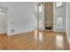 Open-concept living room with a stone fireplace, hardwood floors, and high ceilings at 2932 Springbluff Ln, Buford, GA 30519