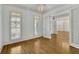 Bright living room with hardwood floors, crown molding and shuttered windows at 2932 Springbluff Ln, Buford, GA 30519