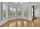 Bright living room with many windows with shutters and a modern light fixture at 2932 Springbluff Ln, Buford, GA 30519