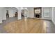 Open-concept living room with a wood-burning fireplace and hardwood floors at 2932 Springbluff Ln, Buford, GA 30519