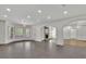 Bright living room with a stone fireplace, arched doorways, and tiled floors at 2932 Springbluff Ln, Buford, GA 30519