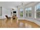 Bright living room with fireplace, many windows with shutters, and a modern light fixture at 2932 Springbluff Ln, Buford, GA 30519