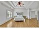 Bright main bedroom suite featuring tray ceilings, hardwood floors and generous space at 2932 Springbluff Ln, Buford, GA 30519