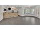 Spacious rec room features tiled flooring, a stone bar, and lots of natural light at 2932 Springbluff Ln, Buford, GA 30519