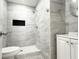 Elegant bathroom featuring a modern walk-in shower with gray marble-patterned tile and a vanity at 2880 Aspen Woods Entry, Doraville, GA 30360