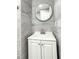 Modern bathroom vanity with round mirror and gray marble-patterned tile walls at 2880 Aspen Woods Entry, Doraville, GA 30360