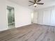 Bright bedroom with modern gray flooring, ceiling fan, and an ensuite bathroom and closet at 2880 Aspen Woods Entry, Doraville, GA 30360